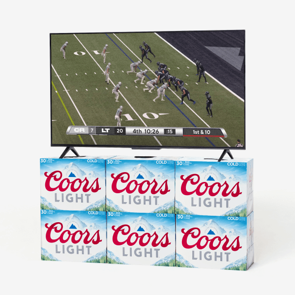 A television displaying a football game placed on top of several Coors Light beer cases against a white background